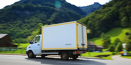 White box truck with yellow conspicuity tape around edges
