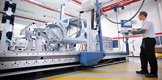3M industrial manufacturing employee controlling an assembly process machine from a terminal.
