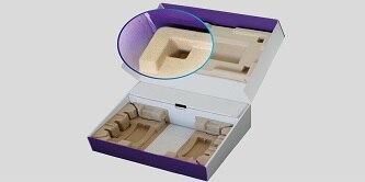 An opened purple and white paperboard box has molded fiber material backed into both sides of the box. The top side of the box is highlighted and enhanced to show the bond. 
