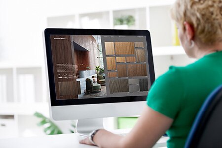 Image of woman using desktop computer to browse interactive catalog.
