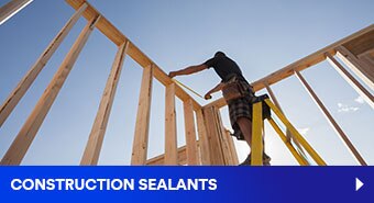 Image of a worker on a ladder in a wall corner of wood-frame construction
