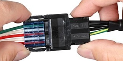 Close-up of 3M Power Clamp Connector being connected, designed for high current and voltage ratings
