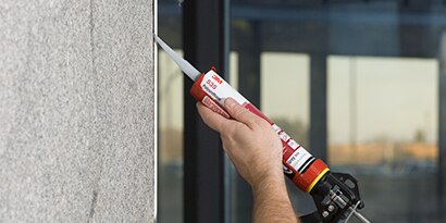 Worker sealing a joint between different materials
