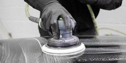 Sander being used on large surface of a car