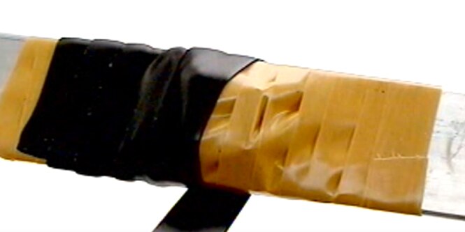 electrical bus bar wrapped in layered electrical tape
