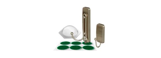 Two brass colored hooks and a sheet of felt pads.
