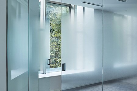 Office conference room glass walls and doors covered with gradated frosted FASARA glass finishes.
