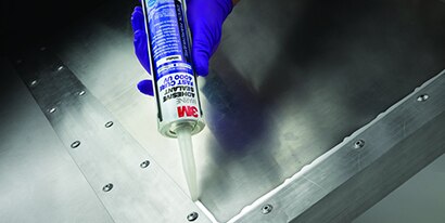 Technician seals a corner with a metal to metal adhesive
