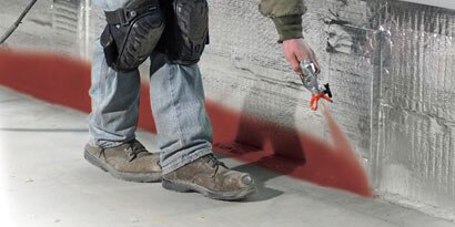 worker spraying flame retardant
