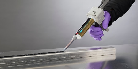 Image of a worker applying 3M™ Scotch-Weld™ Low Odor Acrylic Adhesive DP8710NS to a stiffener

