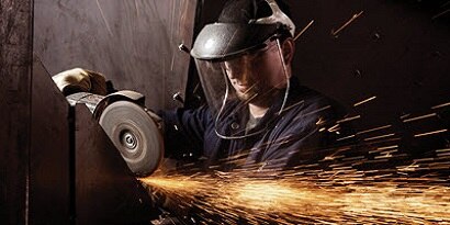 Photo of a metal worker using an angle grinder
