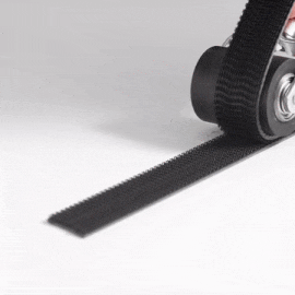 Still image from a repeating GIF showing a hand using a roller to snap together a strip of 3M™ Dual Lock™