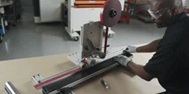 A man wearing safety equipment uses the 3M™ Straight Line Laminator
