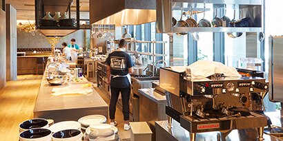A commercial kitchen is functional and organized with attractive fixtures.
