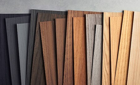 Image of 3M DINOC wood grain samples organized from black to light wood tones.
