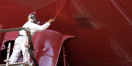 Using the 3M Performance Spray Gun for painting the exterior of a military vessel for corrosion prevention.
